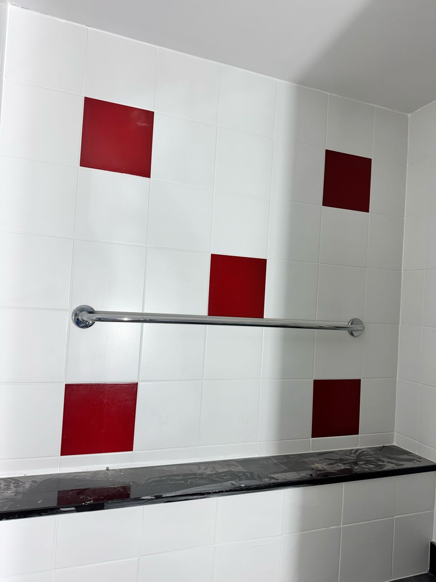Recoloured bathroom wall tiles after restoration